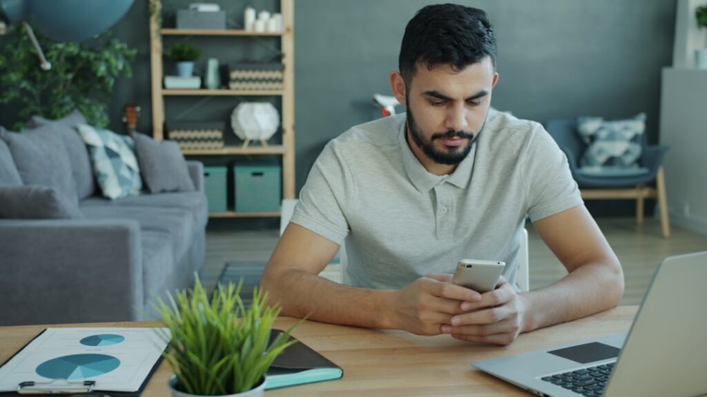 Sales professional using Odoo mobile ERP app on smartphone